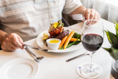 Close-up of a dining experience with food and wine.