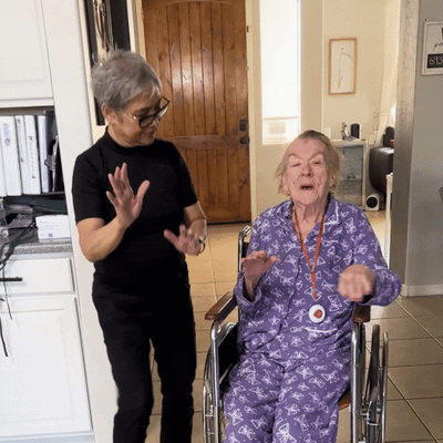 Resident and staff member interacting joyfully.
