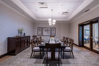 Elegant dining area with a large table set for meals.