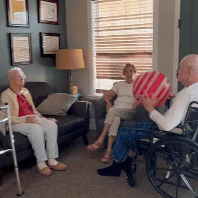 Residents engaging in a ball game indoors.