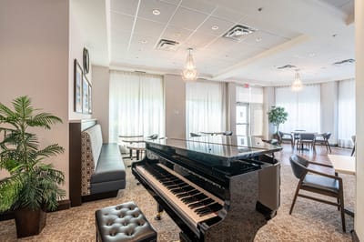Interior common area with a piano and seating.