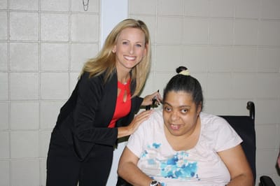 Staff member posing with a resident in a facility.