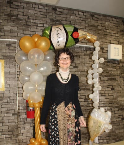 Resident celebrating at a decorated event.