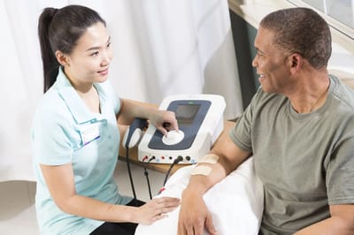 Healthcare worker assisting resident with therapy