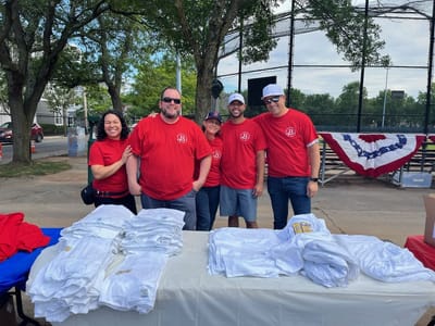 Staff members in matching red shirts at an event.