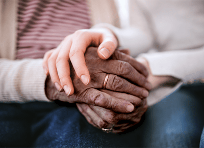 Close-up of hands of different ages holding each other