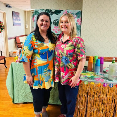 Staff members in colorful outfits celebrating an event.