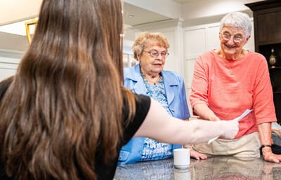 Residents engaged with staff in a common area