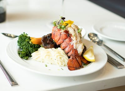 Gourmet lobster dish with vegetables and pasta