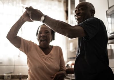 Two seniors enjoying a moment in the kitchen.