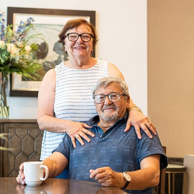A smiling couple in a common area.