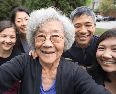 Residents and family pose together outdoors.