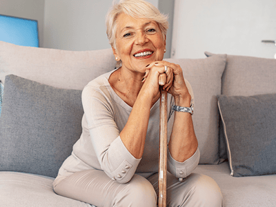 Senior woman smiling while sitting on a couch