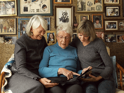Three women sharing a moment in a cozy interior space.