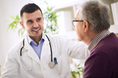 Healthcare professional interacting with an elderly patient.