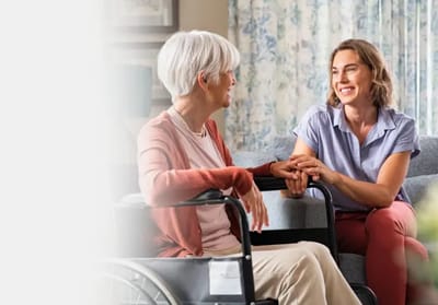 Caregiver interacting with a resident in a cozy setting.