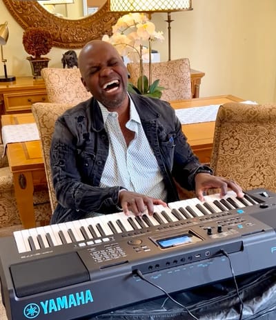 Musician performing joyfully at a piano