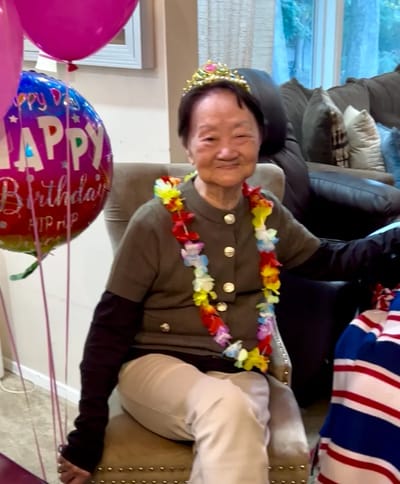 Senior woman celebrating birthday with decorations