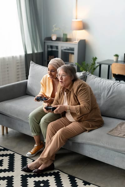 Two seniors enjoying a video game session.