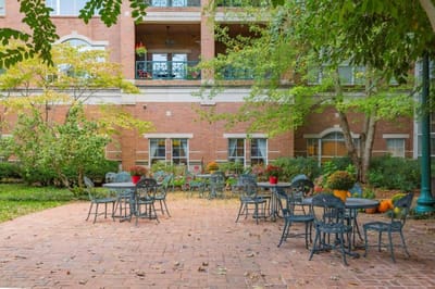 Outdoor seating area with tables and plants.