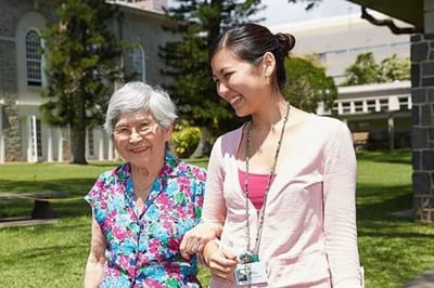 Resident and staff member enjoying a walk outside.