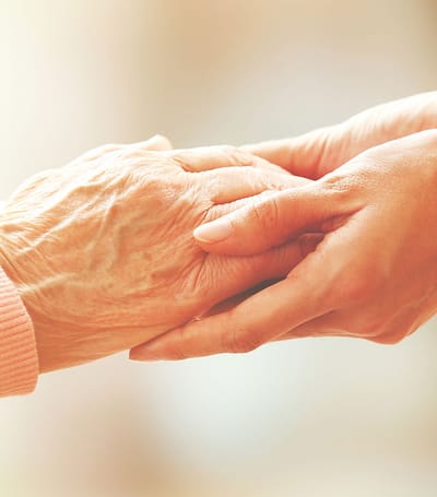 Two hands clasped together in support.