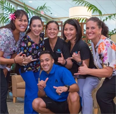 Group of staff posing happily indoors