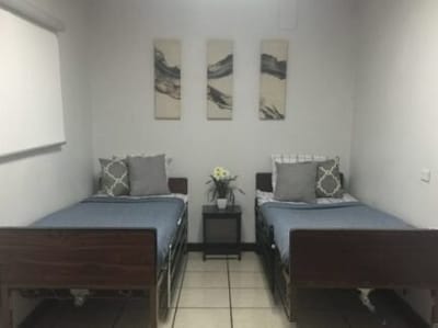 A shared bedroom with two beds