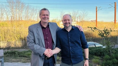 Two men shaking hands outside