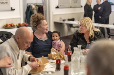 Residents enjoying food together at a table.
