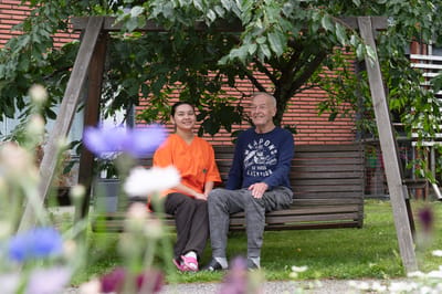 Resident and staff enjoying time together outdoors.