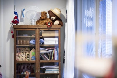 Decorative cabinet with teddy bears and books.