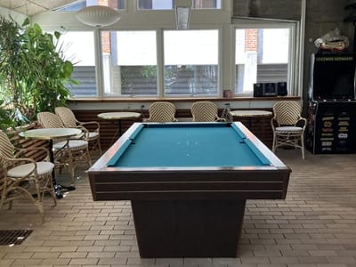 Common area with a pool table and seating.