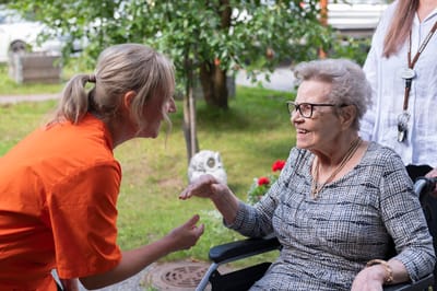 Care staff engaging with a resident outdoors.