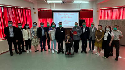 Group photo of staff and residents in a common area