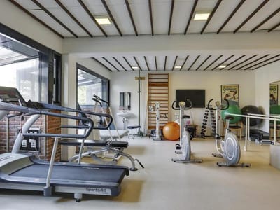 Interior of a fitness room with exercise equipment.