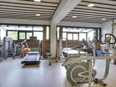 Gym area with various exercise equipment.
