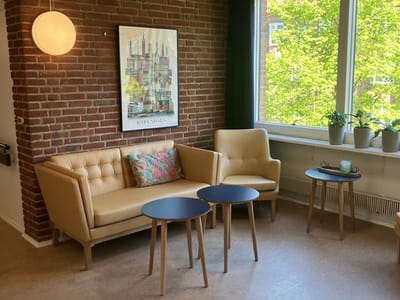Cozy seating area with plants and artwork
