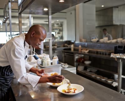 Chef plating a meal in the kitchen
