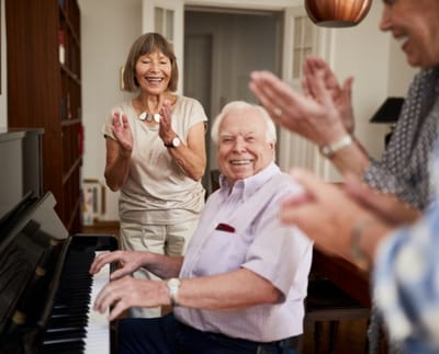 Residents enjoying a piano performance together.