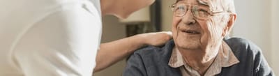 Caregiver interacting with elderly resident.
