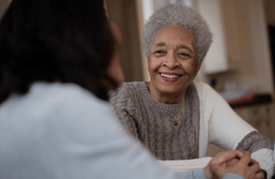 Senior resident smiling while engaging with another person