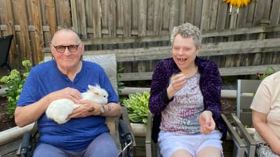 Residents enjoying time outdoors with a rabbit.