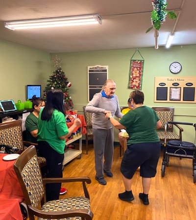 Residents and staff celebrating with a Christmas tree