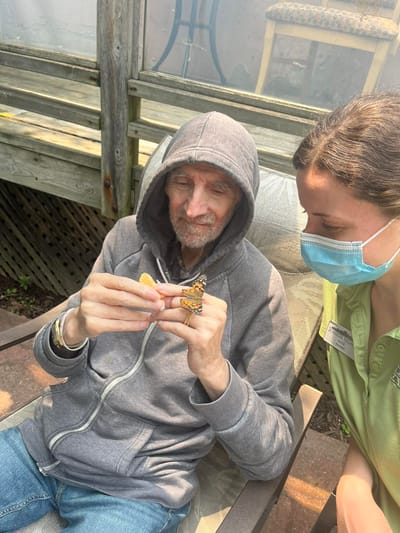 Senior resident and staff member enjoying nature.