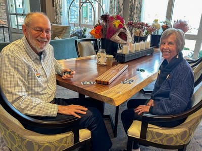Two residents enjoying time together in the common area.