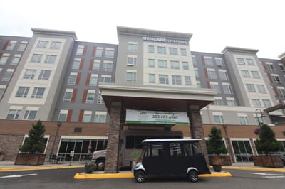 Front view of GenCare Lifestyle Tacoma facility with a transport vehicle