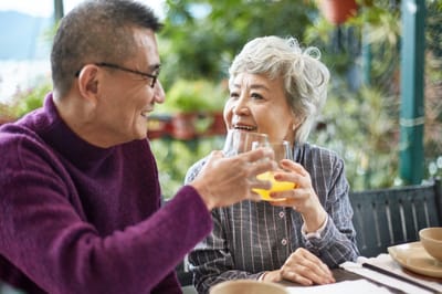 Two residents enjoying drinks at an outdoor table