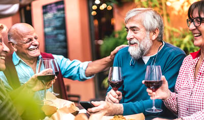 Residents enjoying wine and laughter at a gathering