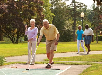 Residents enjoying outdoor activities in a beautiful garden